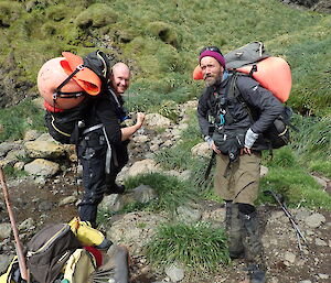 two expeditioners with marine debris