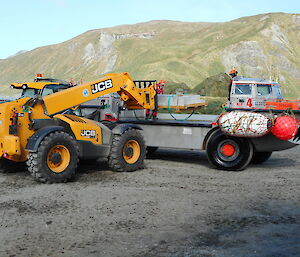 A telehandler unloads a consignment from a truck