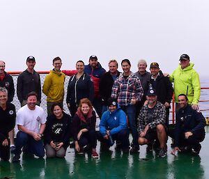 Group photo of expeditioners on the deck of the ship