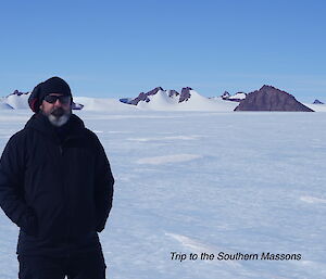 Man standing in front of a mountain range