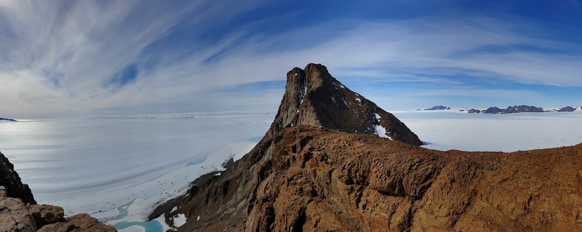 A mountain and looking towards the coast and grounded icebergs