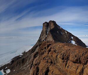 A mountain and looking towards the coast and grounded icebergs