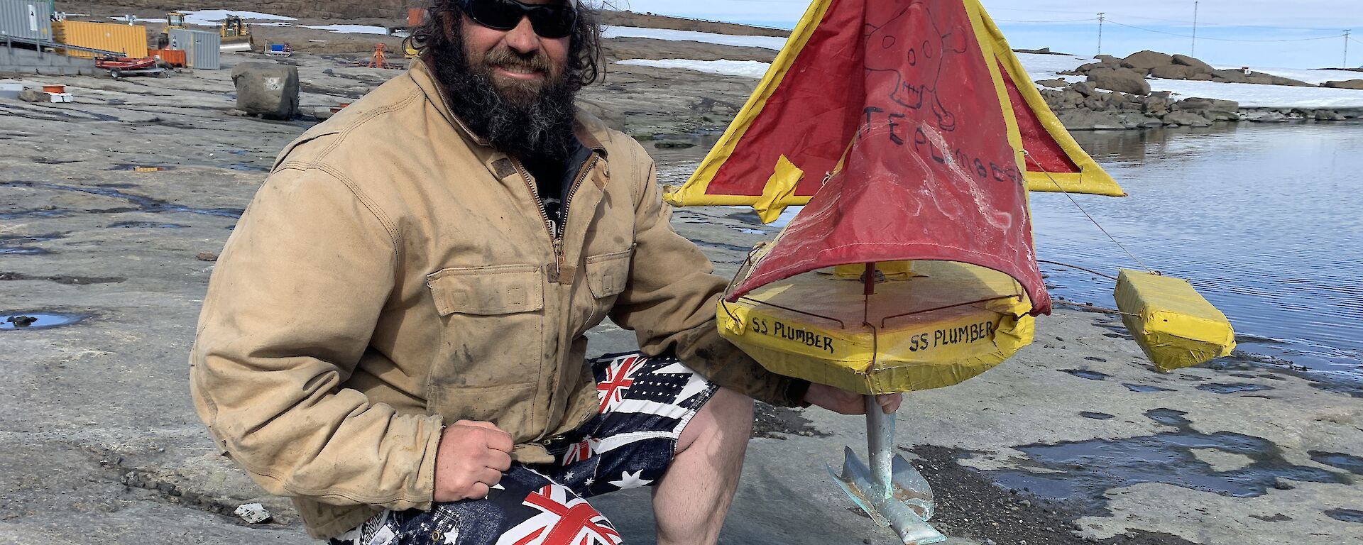 a man with his hand made sail boat