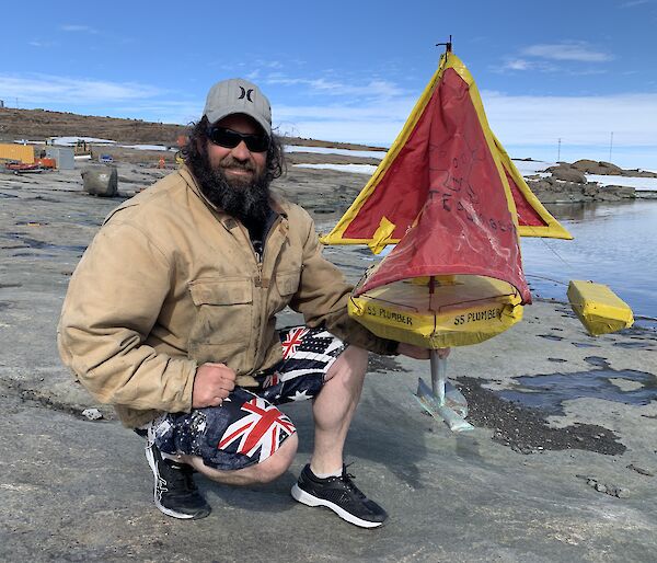a man with his hand made sail boat