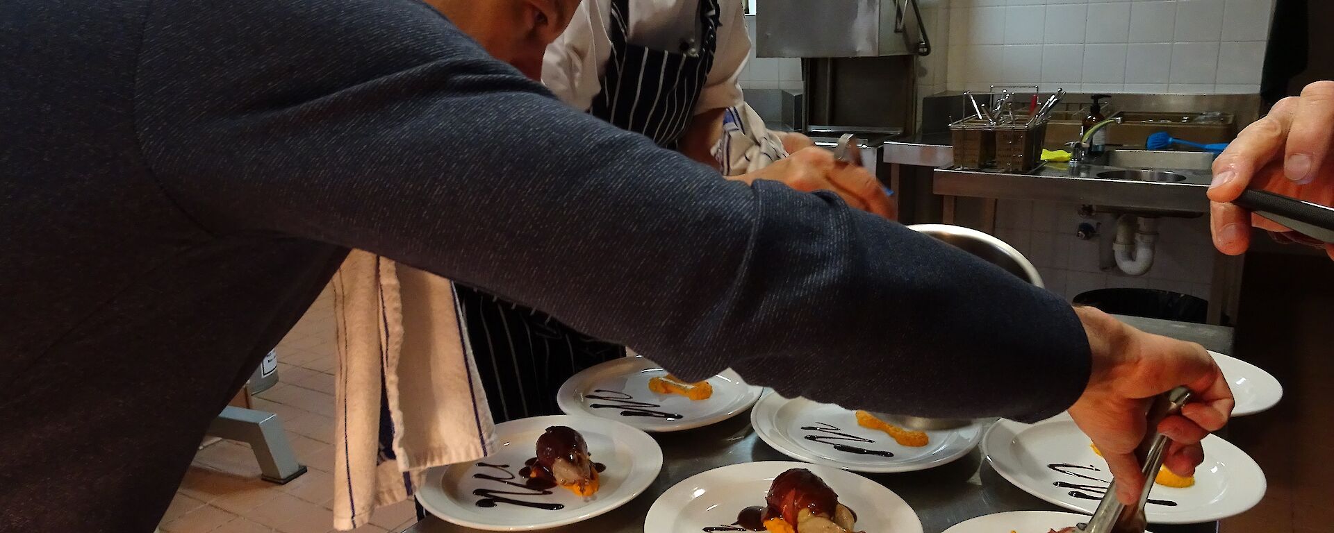 Plating up the Mawson end of season dinner 2019–20 with Chef Kim De Laive.