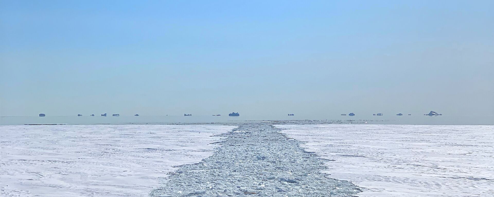 Looking back from the ship at a long trail of broken sea ice