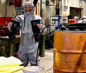 A mechanic wearing a fuel spill suit for a drill