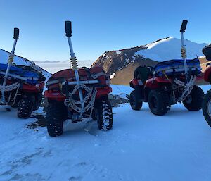 Four quad bikes parked on the ice