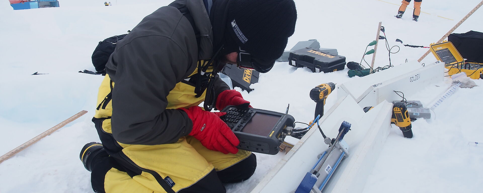 Scientist takes microwave measurements of a thin section of ice core