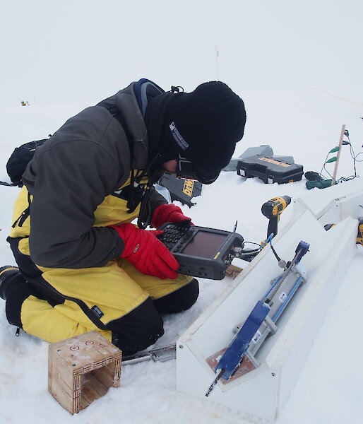 Scientist takes microwave measurements of a thin section of ice core