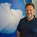 Australian Antarctic Data Centre Manager Dr Johnathan Kool in front of Antarctic map.