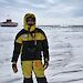 Kim Ellis standing on the ice with China’s Taishan station in the background.