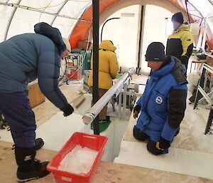 Scientists with an ice core drill in Antarctica.