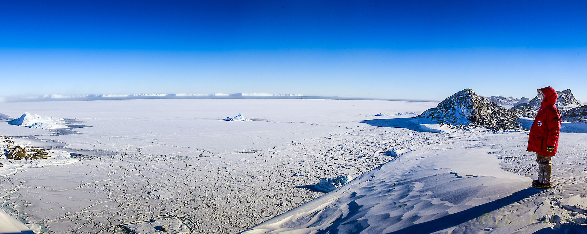 person in panorama of icy landscape