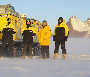 people in icy landscape next to vehicle