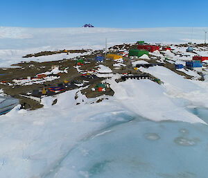 Antarctic station with wind turbine surrounded by ice