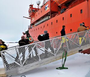 people,passing bags down gangway of ship