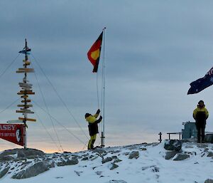 people with flags at dawn