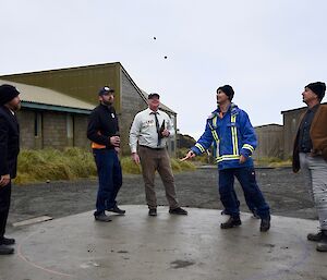 group of men playing two-up