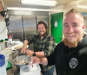 Two of the plant operators preparing a meal in the kitchen