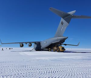 C17 aircraft unloading a tractor on an ice runway