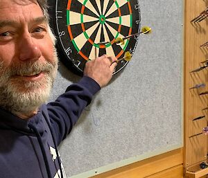 A man playing darts