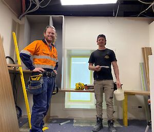 Two men installing the wallow ceiling