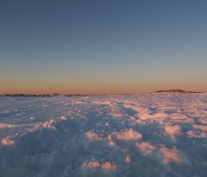 Horizon and snow landscape of sunrise glow on the snow