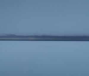 The blue/grey horizon helps to differentiate the snow and the cloud near Casey