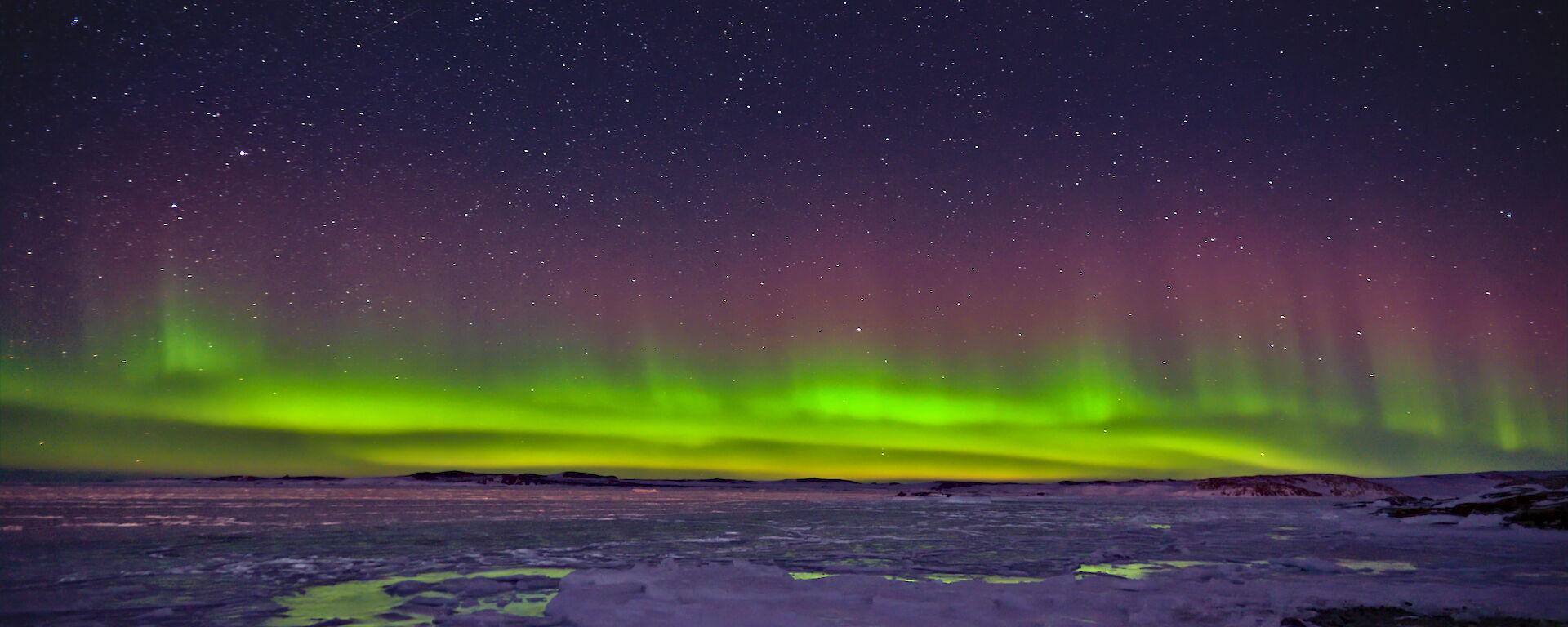 A multi-coloured Aurora over Newcomb Bay near Casey station