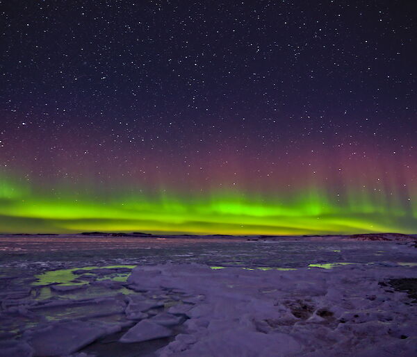 A multi-coloured Aurora over Newcomb Bay near Casey station