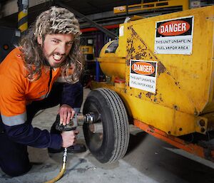 An expeditioner fixing a wheel onto a vehicle