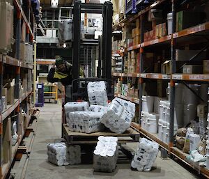 An expeditioner accidentally dropping toilet rolls from the pallet on the forklift