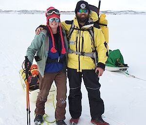 Two expeditioners on the sea ice between Davis and Anchorage Island on a cloudy day