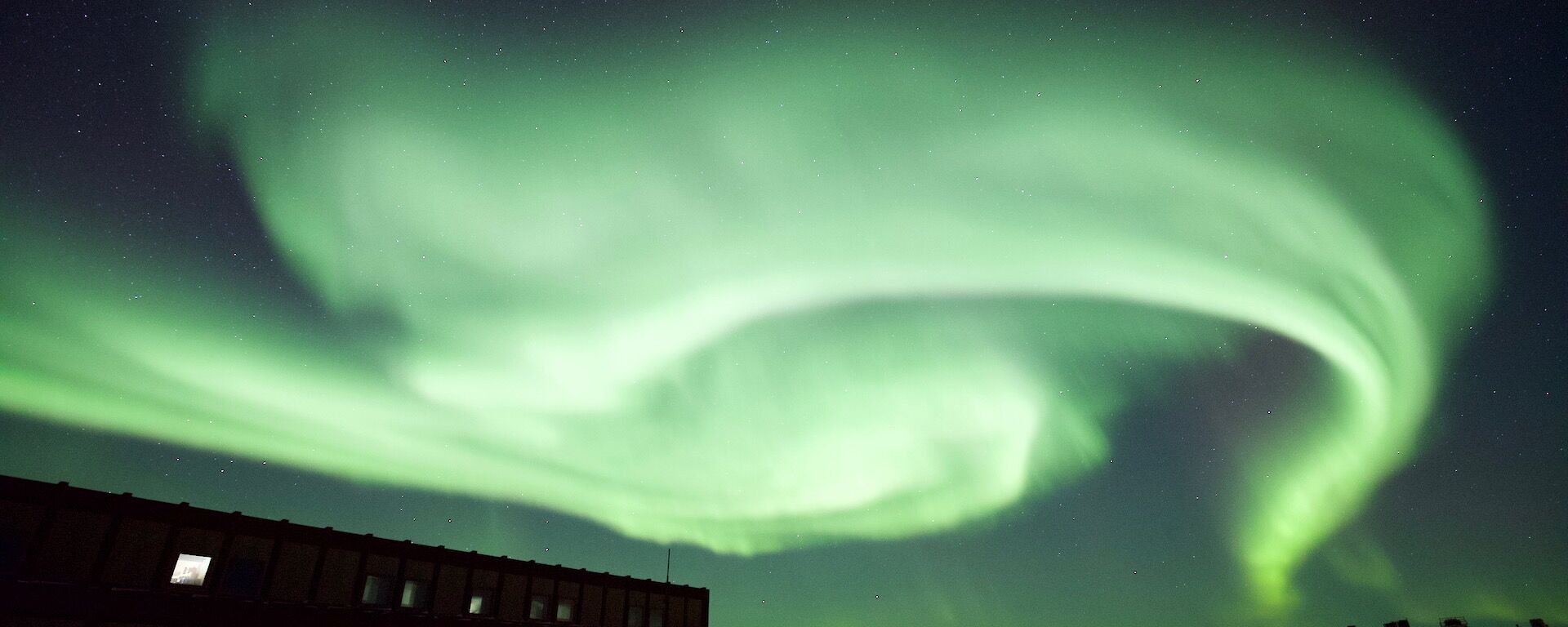 A green aurora australis lights up the sky above the workshop