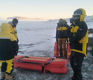 Four expeditioners preparing a search and rescue sled