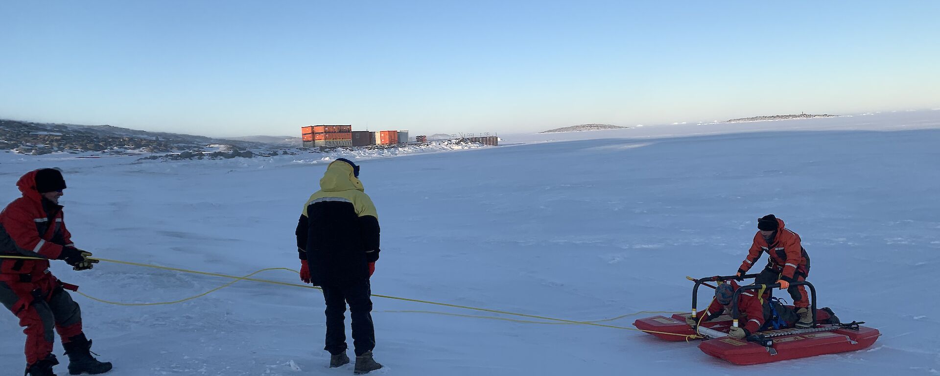 Three expeditioners undertaking a search and rescue exercise