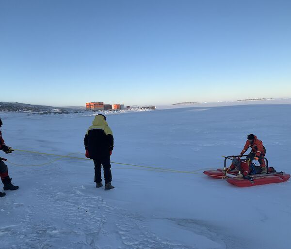 Three expeditioners undertaking a search and rescue exercise