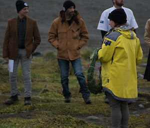 An expeditioner placing a wreath on the ground