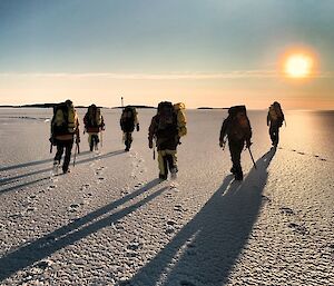 Group of expeditioners walking across the sea ice
