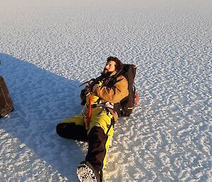 an expeditioner lying on the ice