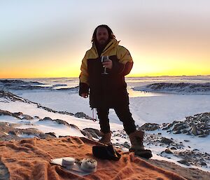 An expeditioner in front of a sunset.