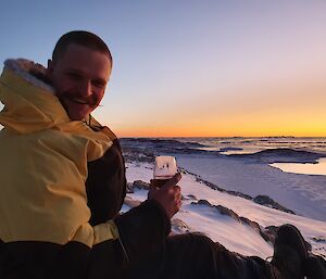 An expeditioner in front of a sunset.