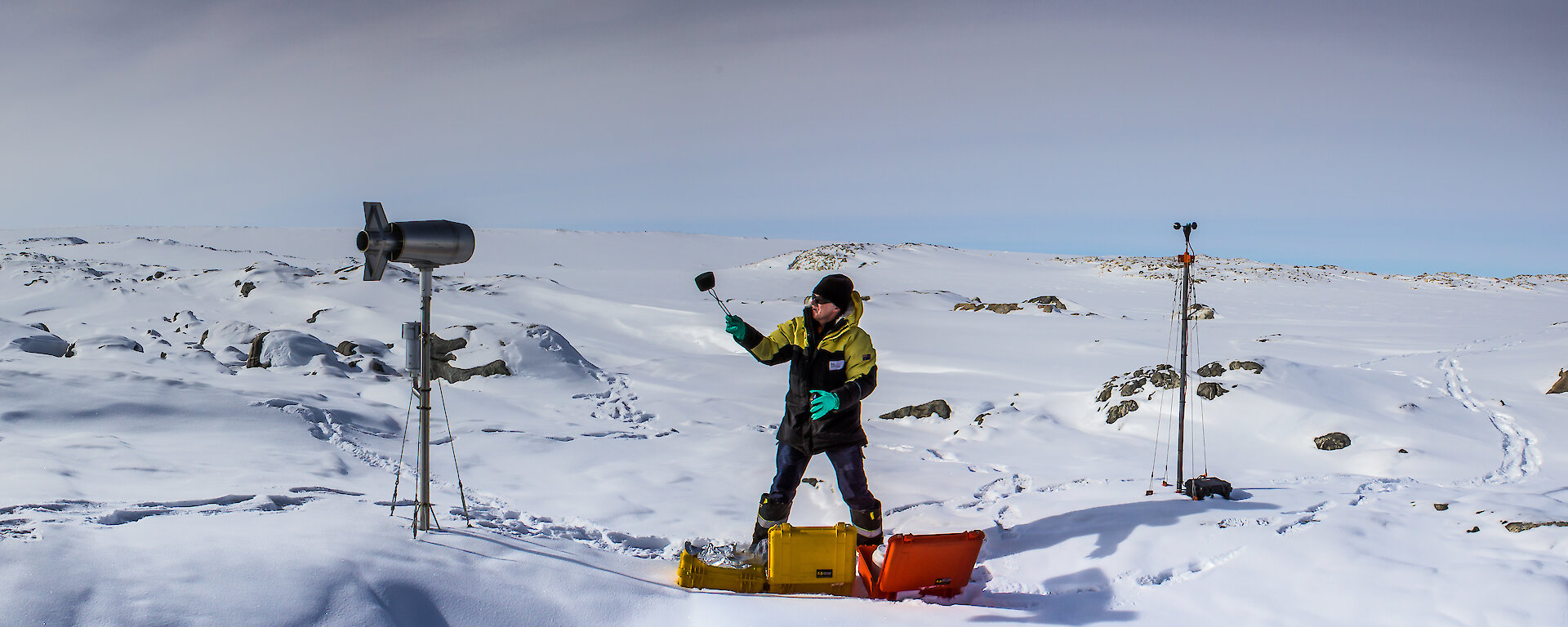 Panorama view of scientist on the ice using equipment to gather air samples and air data