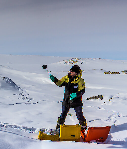 Panorama view of scientist on the ice using equipment to gather air samples and air data
