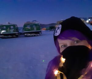 Self portrait of the station leader wearing a purple wig and a necklace of fairy lights