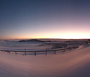 Panoramic view of the sun rising over the ice