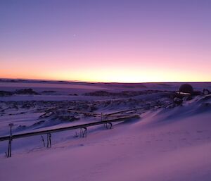 The sun about to rise above the ice plateau