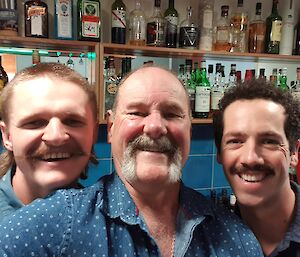 Three men show off their facial hair