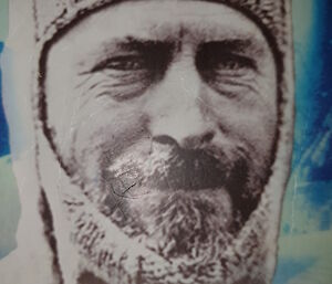 An image of an old photo of a man wearing a balaclava with his beard